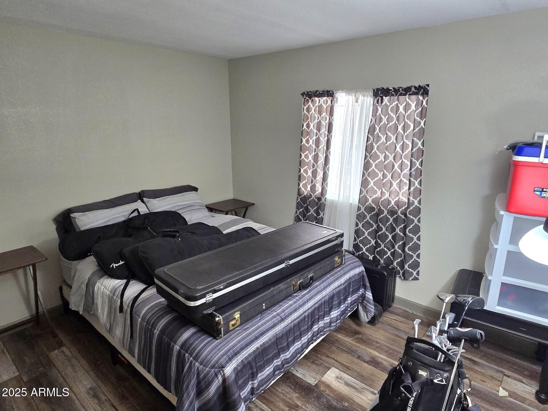 2900 West Superstition Boulevard, Unit 46 Apache Junction, AZ 85120 - Photo 22 of 26 a bed sitting in a bedroom next to a window