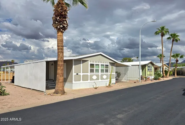 a front view of a house with a garden and street view