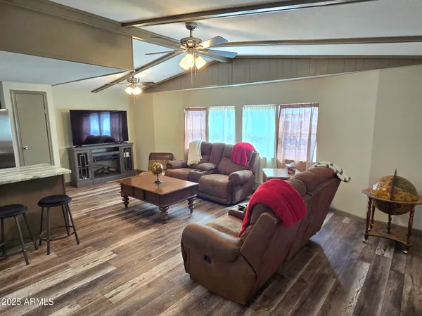 a living room with furniture a large window and a flat screen tv