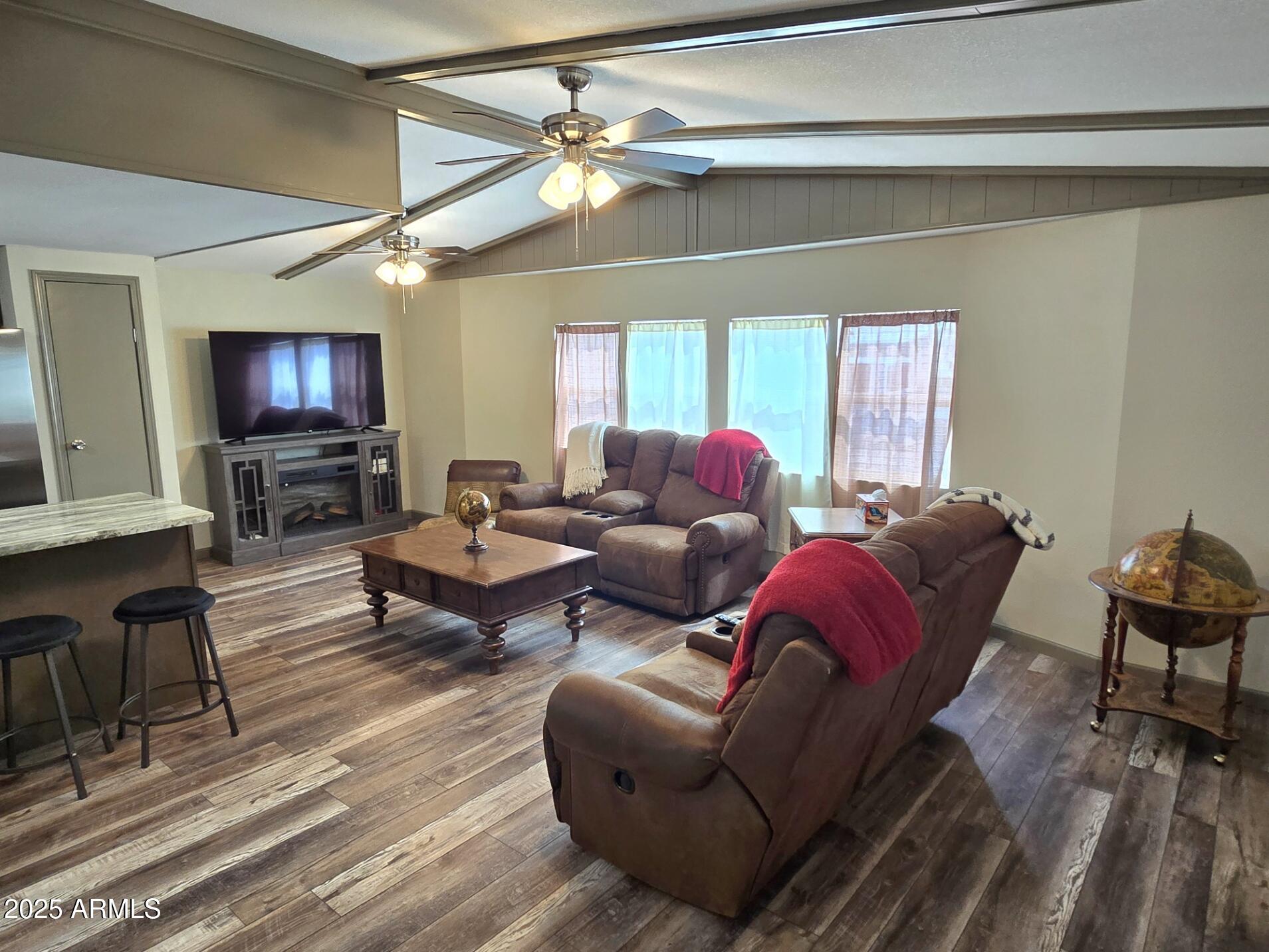 2900 West Superstition Boulevard, Unit 46 Apache Junction, AZ 85120 - Photo 5 of 26 a living room with furniture a large window and a flat screen tv