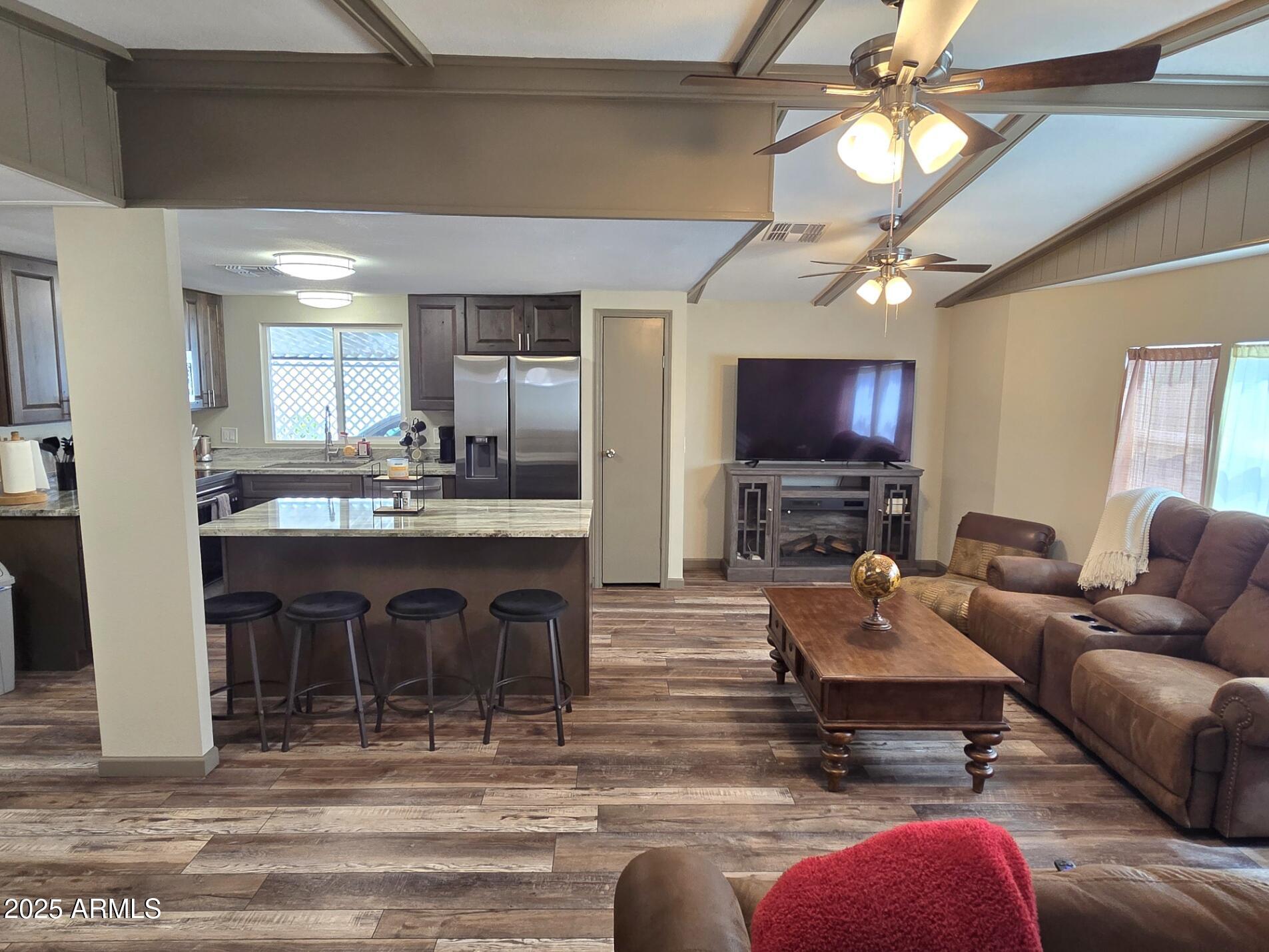 2900 West Superstition Boulevard, Unit 46 Apache Junction, AZ 85120 - Photo 6 of 26 a living room with fireplace furniture and a flat screen tv