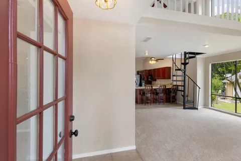 a view of a livingroom with furniture and a hallway
