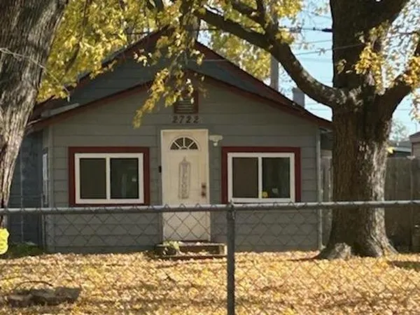 a view of a house with a large tree