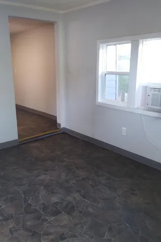 an empty room with an empty space and windows