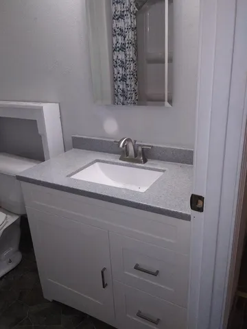 a bathroom with a sink and a mirror
