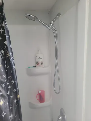 a bathroom with a glass shower door