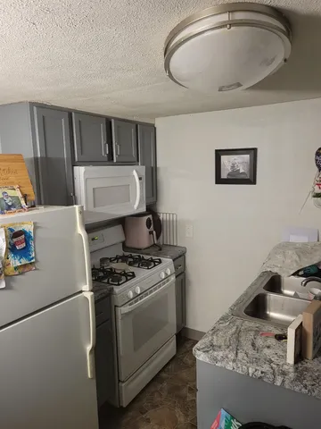 a kitchen with a stove and a refrigerator