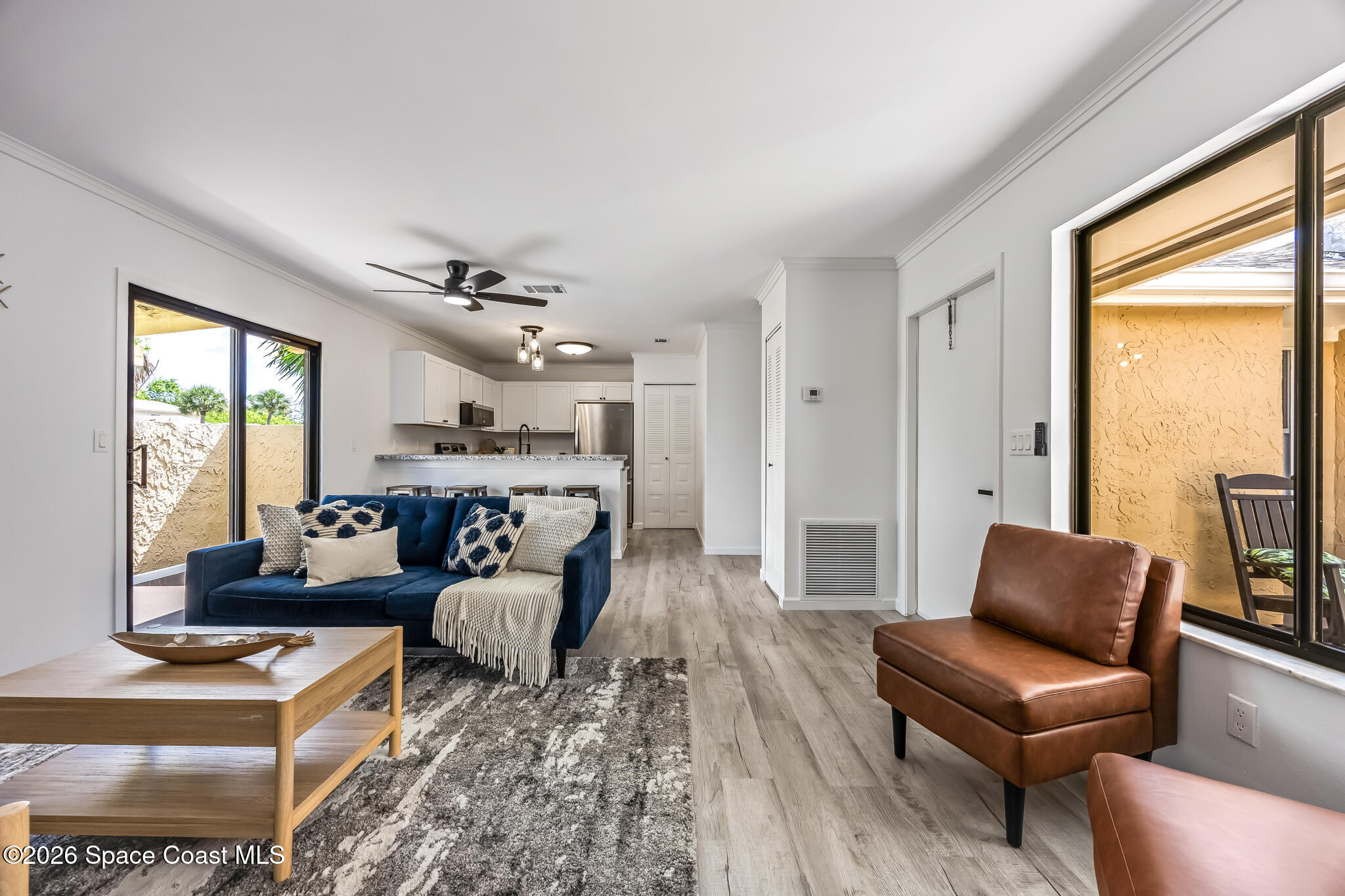 1411 Sheafe Avenue Northeast, Unit 101 Palm Bay, FL 32905 - Photo 6 of 24 a living room with furniture and a large window