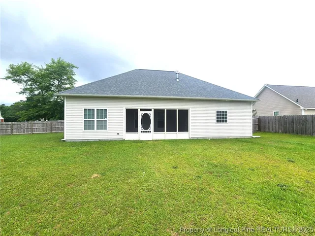 a view of a house with a backyard