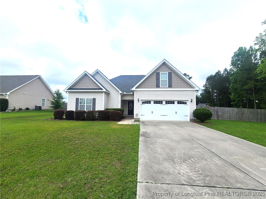 265 Carolina Oaks Circle Linden, NC 28356 - Photo 2 of 31 a front view of a house with yard and green space