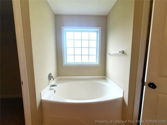 a white bath tub sitting next to a window