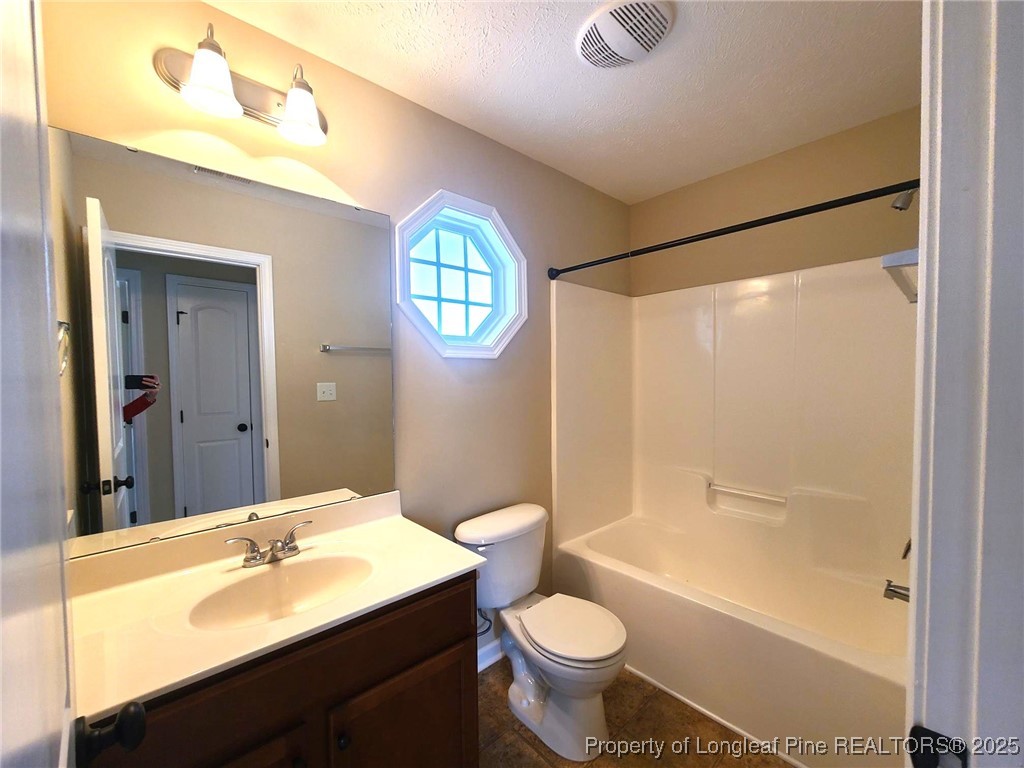 265 Carolina Oaks Circle Linden, NC 28356 - Photo 26 of 31 a bathroom with a sink a toilet and shower