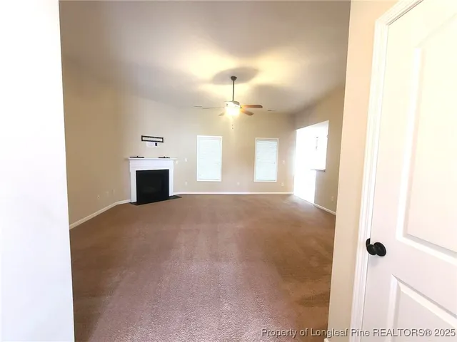 a view of empty room with a fireplace