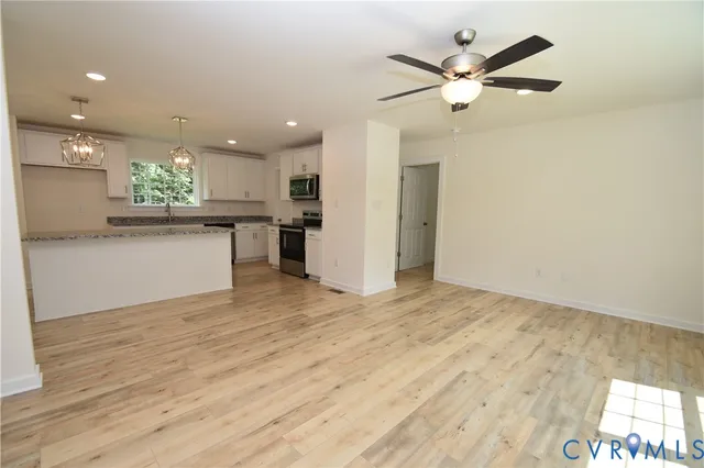 a view of a kitchen with a sink and a refrigerator