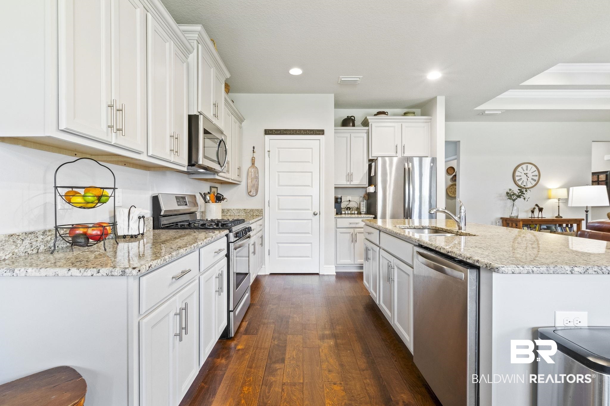 31663 Kestrel Loop Daphne, AL 36527 - Photo 23 of 86 Kitchen with white cabinets, appliances with stainless steel finishes, sink, dark hardwood / wood-style floors, and a kitchen island with sink