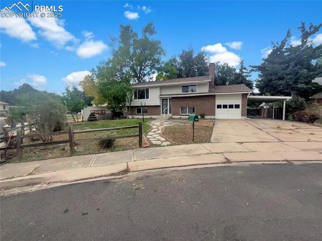 a view of a house with car parked