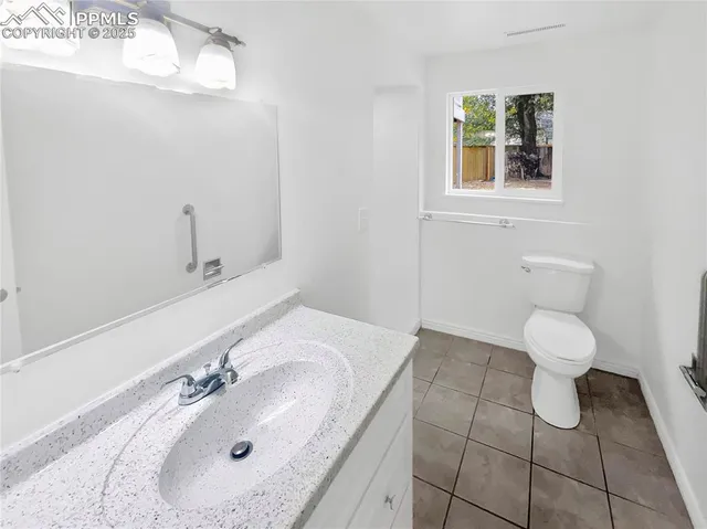 a bathroom with a sink toilet and mirror
