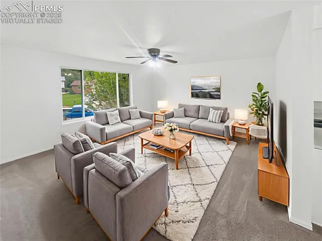 a living room with furniture and a large window