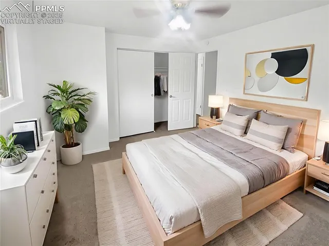 a bedroom with a bed and ceiling fan