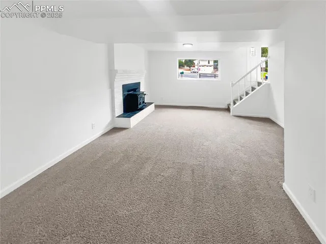 a view of an empty room with a fireplace