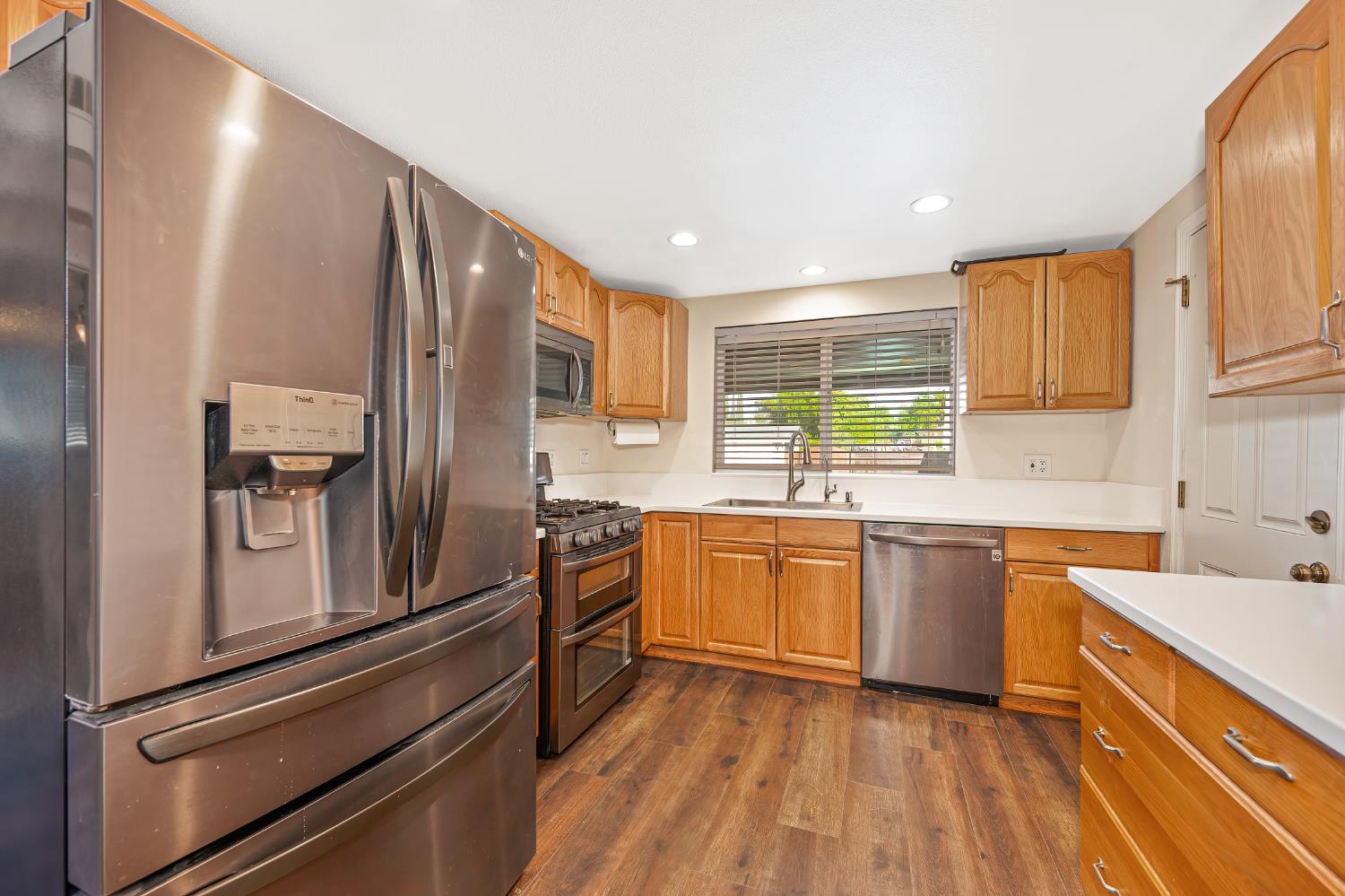 2700 Lassen Way Rocklin, CA 95677 - Photo 11 of 36 a kitchen with stainless steel appliances granite countertop a sink stove and refrigerator