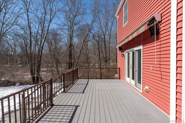 a view of balcony with wooden floor and fence