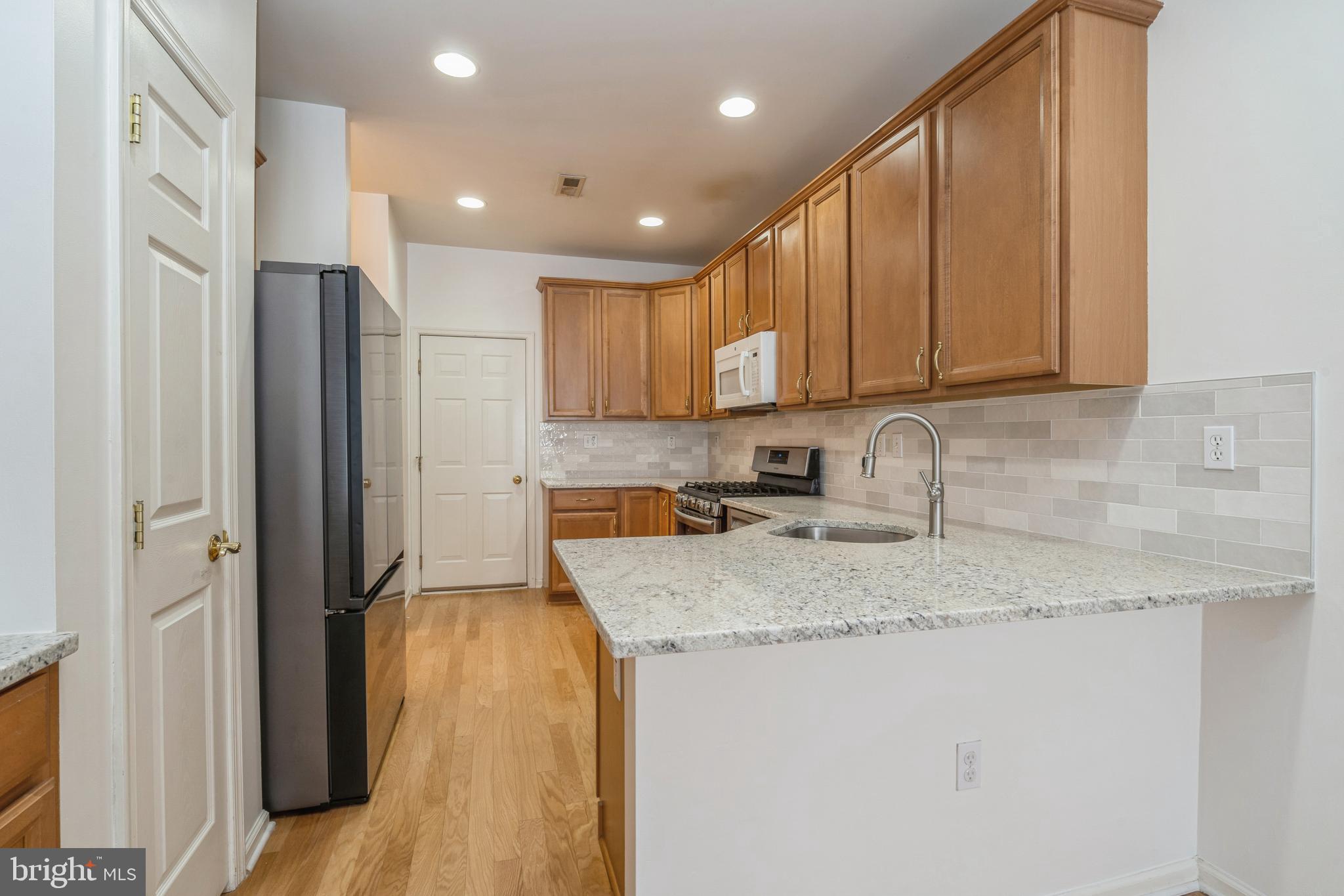 250 Brinley Drive Pennington, NJ 08534 - Photo 11 of 34 a kitchen with stainless steel appliances granite countertop a refrigerator sink and cabinets
