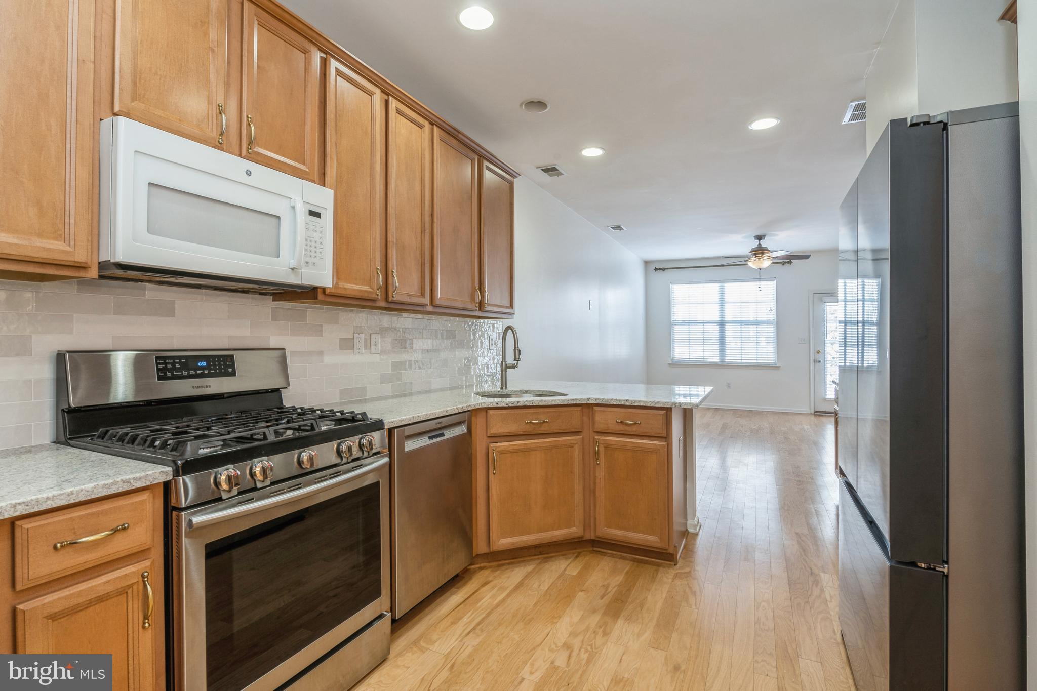 250 Brinley Drive Pennington, NJ 08534 - Photo 12 of 34 a kitchen with stainless steel appliances granite countertop a stove a sink and a microwave