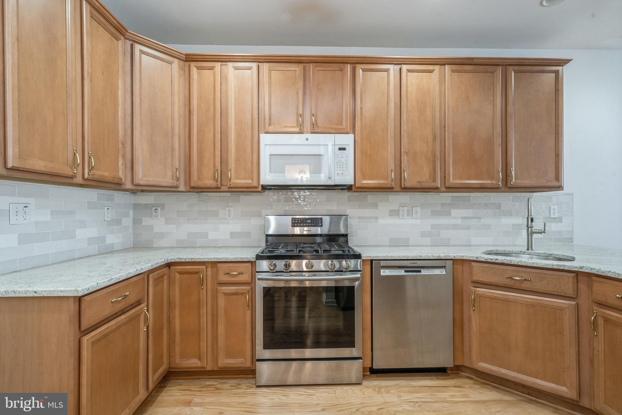 250 Brinley Drive Pennington, NJ 08534 - Photo 16 of 34 a kitchen with cabinets appliances and a sink