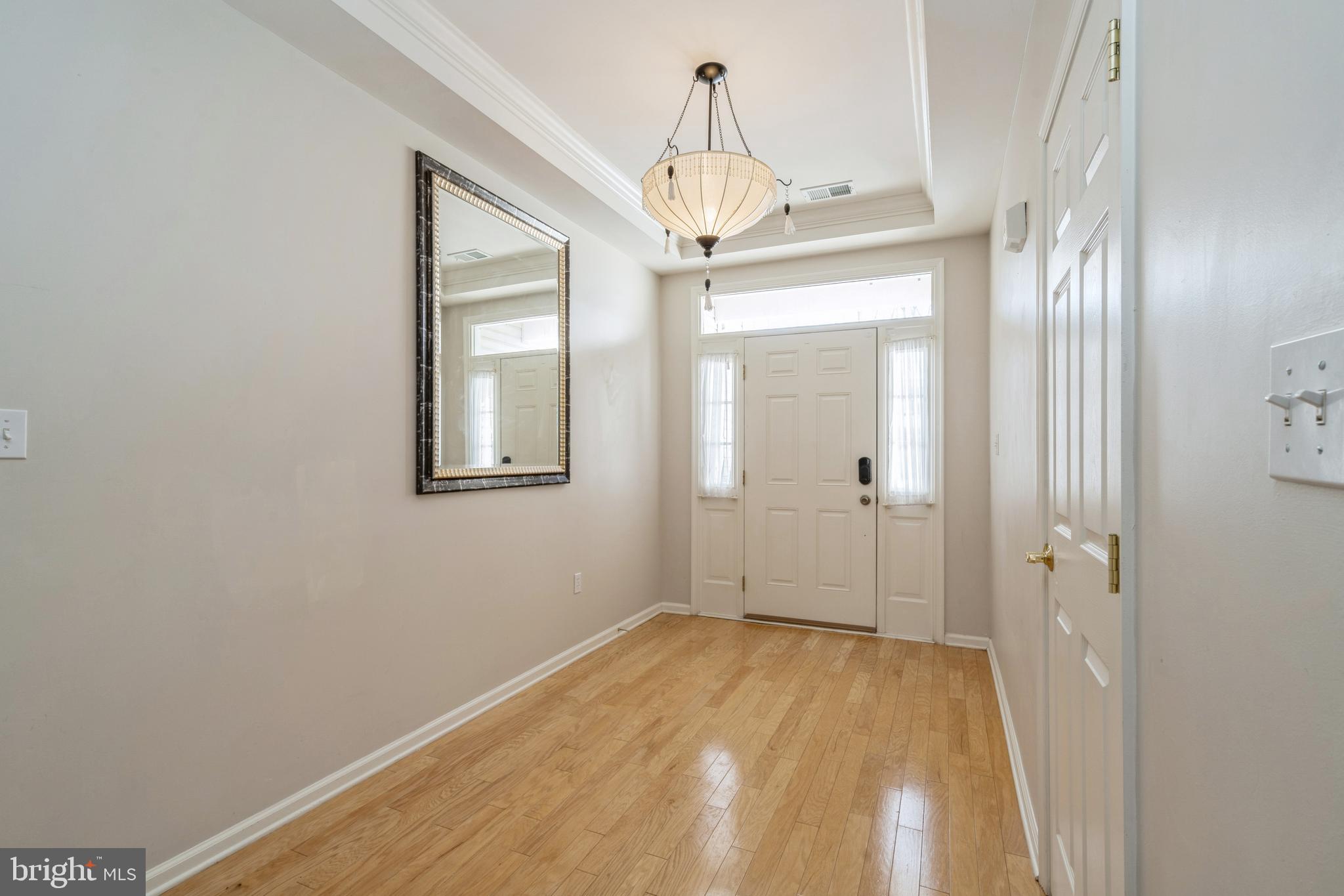 250 Brinley Drive Pennington, NJ 08534 - Photo 3 of 34 a view of a hallway with a chandelier