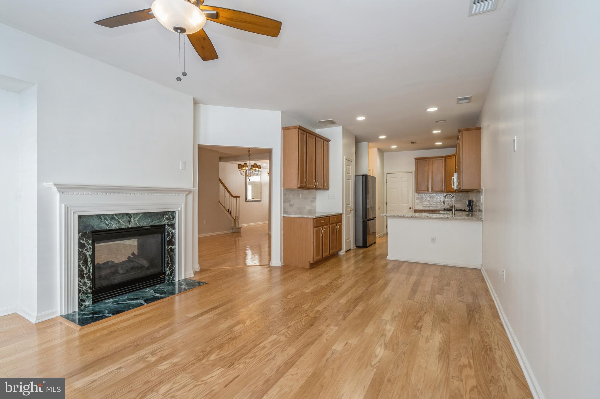 250 Brinley Drive Pennington, NJ 08534 - Photo 9 of 34 a view of a kitchen with a sink a fireplace and a window