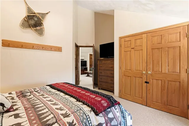 a bedroom with a bed and a cabinet