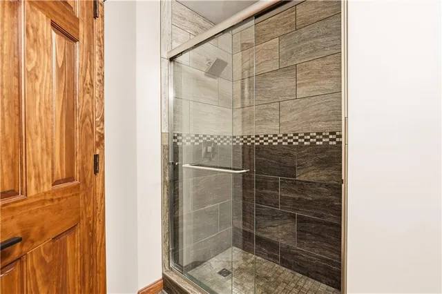 a bathroom with a glass door shower