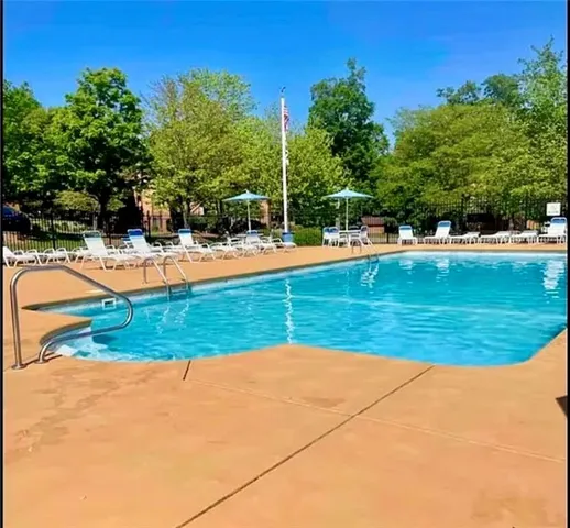 a view of a swimming pool with a yard