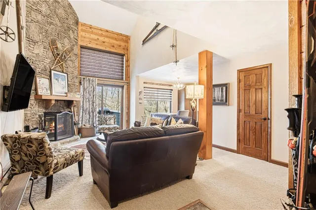 a living room with furniture a flat screen tv and a large window
