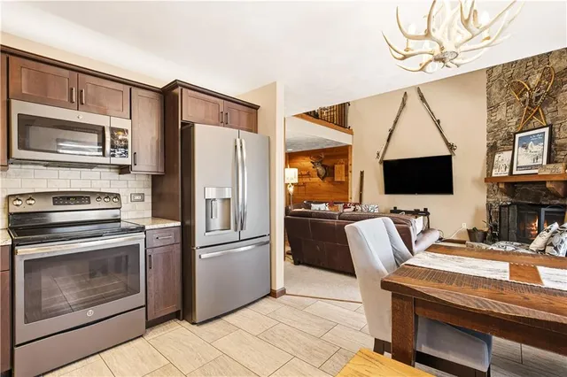 a kitchen with stainless steel appliances a stove microwave and refrigerator