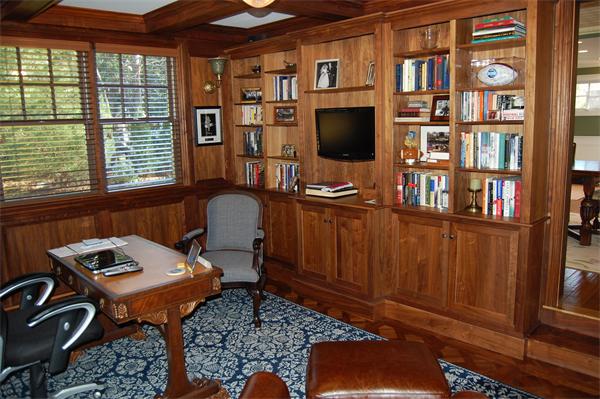 692 Boston Post Road Weston, MA 02493 - Photo 5 of 8 a room with bookshelf and a flat screen tv
