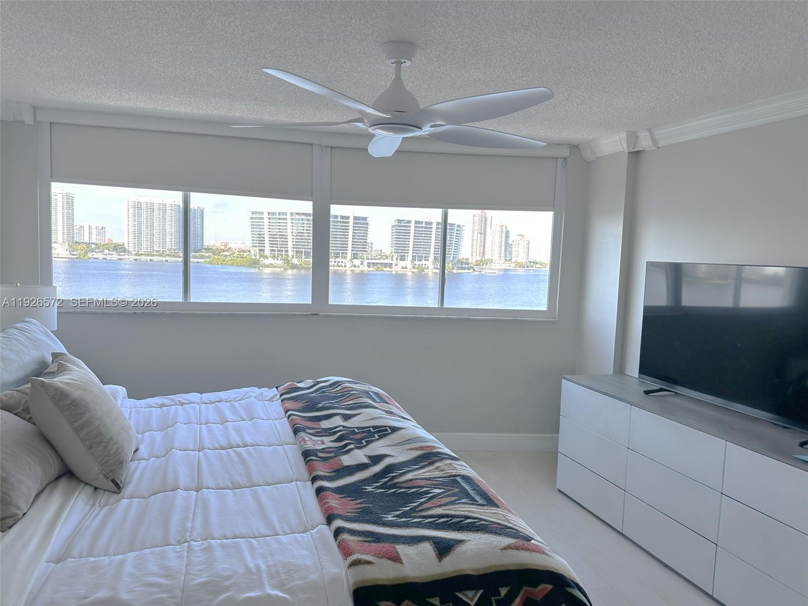 18000 North Bay Road, Unit 603 Sunny Isles Beach, FL 33160 - Photo 18 of 30 a bedroom with a bed and flat screen tv