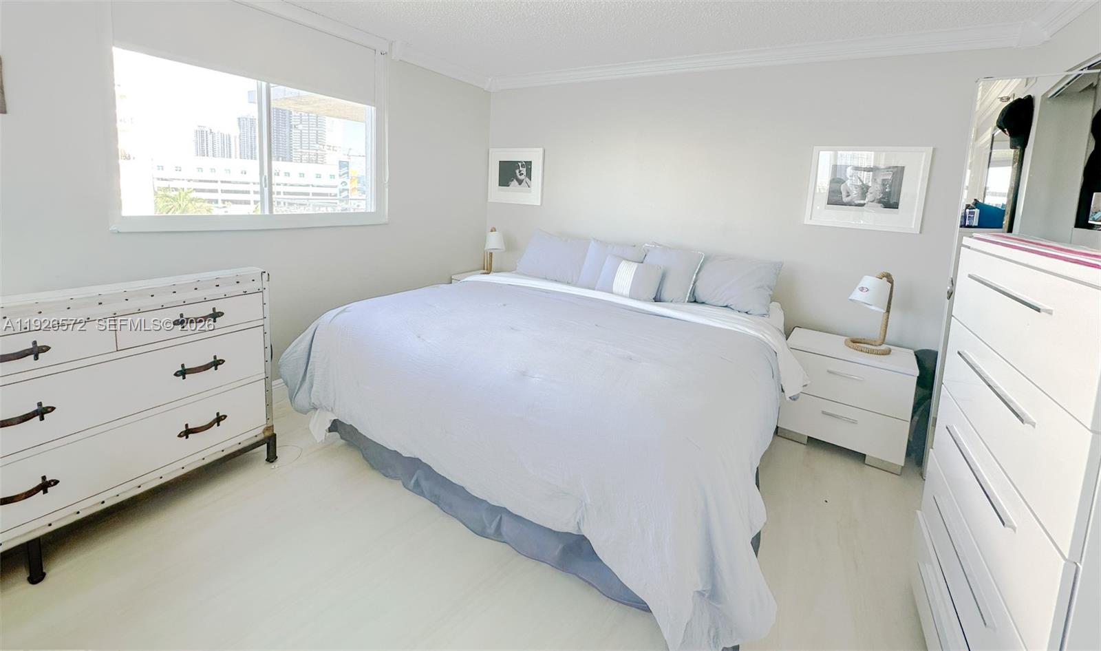 18000 North Bay Road, Unit 603 Sunny Isles Beach, FL 33160 - Photo 21 of 30 a bed room with a bed and a window