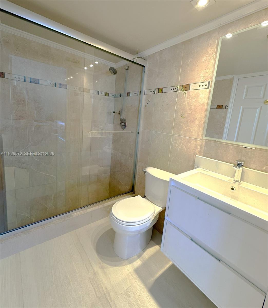 18000 North Bay Road, Unit 603 Sunny Isles Beach, FL 33160 - Photo 23 of 30 a bathroom with a sink toilet and shower