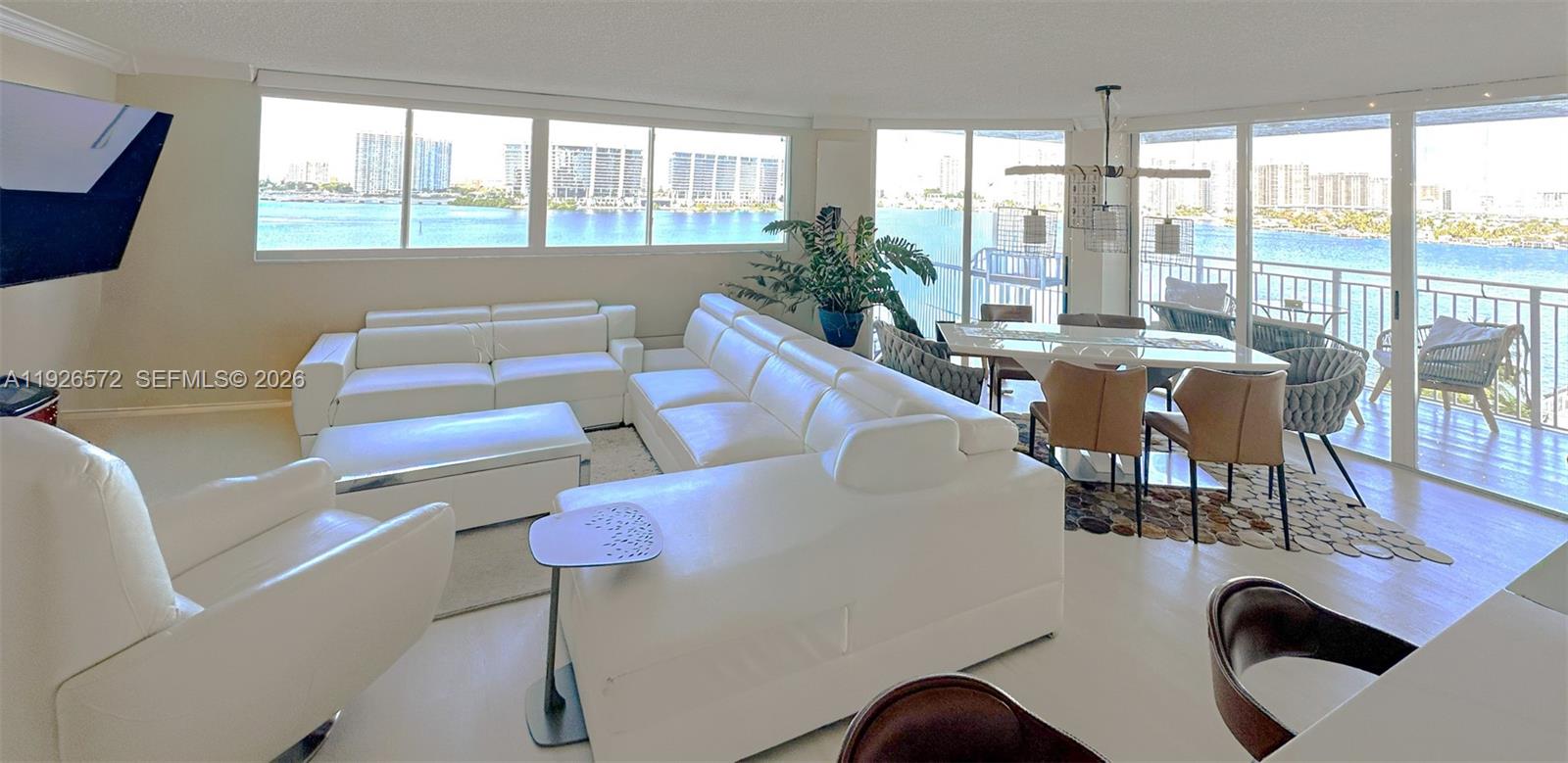 18000 North Bay Road, Unit 603 Sunny Isles Beach, FL 33160 - Photo 6 of 30 a living room with furniture and a floor to ceiling window