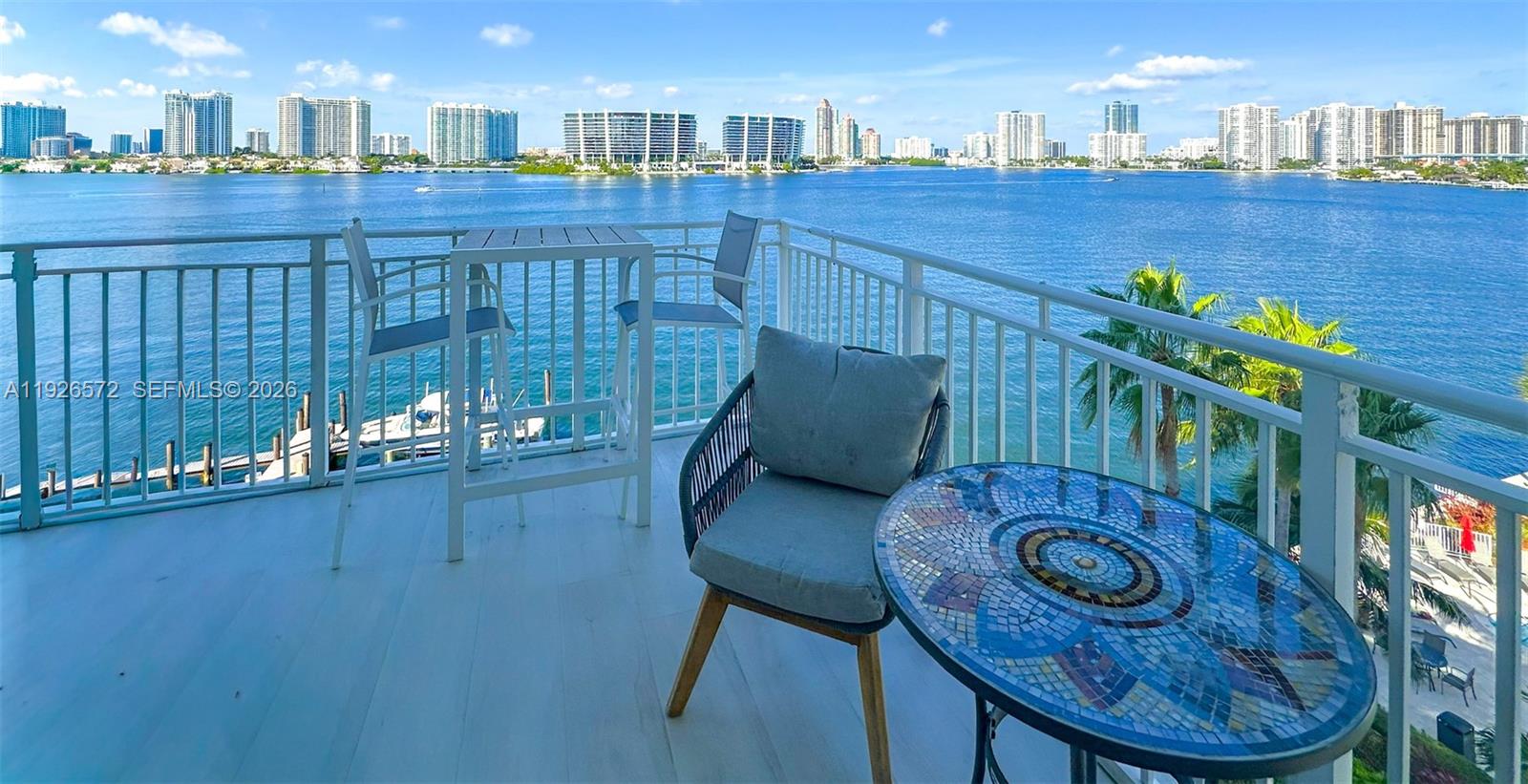 18000 North Bay Road, Unit 603 Sunny Isles Beach, FL 33160 - Photo 8 of 30 a view of a dining room with furniture and wooden floor
