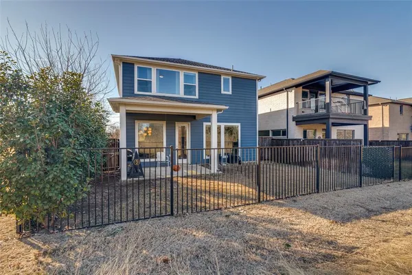 a front view of a house with iron fence