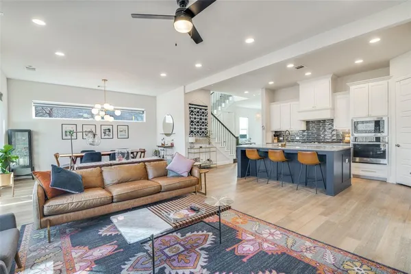 a living room with furniture and kitchen view