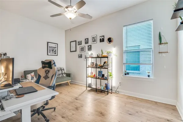 a view of a workspace with furniture and a window