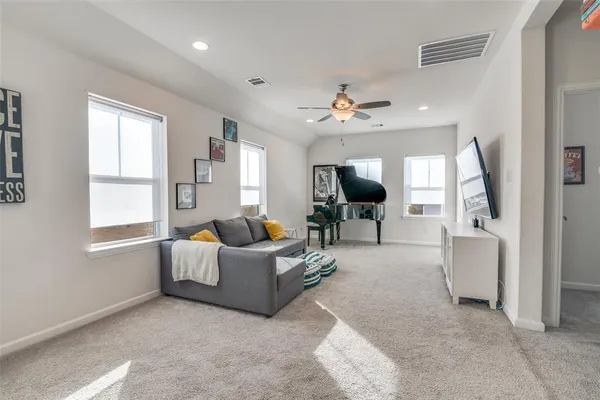 a living room with furniture and a chandelier
