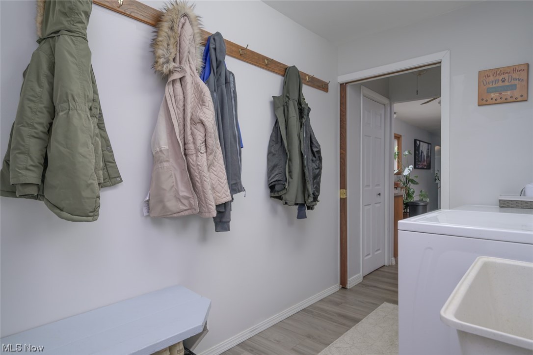 1165 Meadowview Road Kent, OH 44240 - Photo 22 of 40 Mudroom featuring independent washer and dryer, sink, and light hardwood / wood-style flooring
