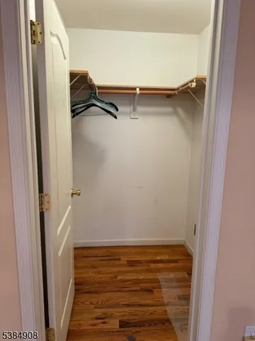 a view of closet with wooden floor