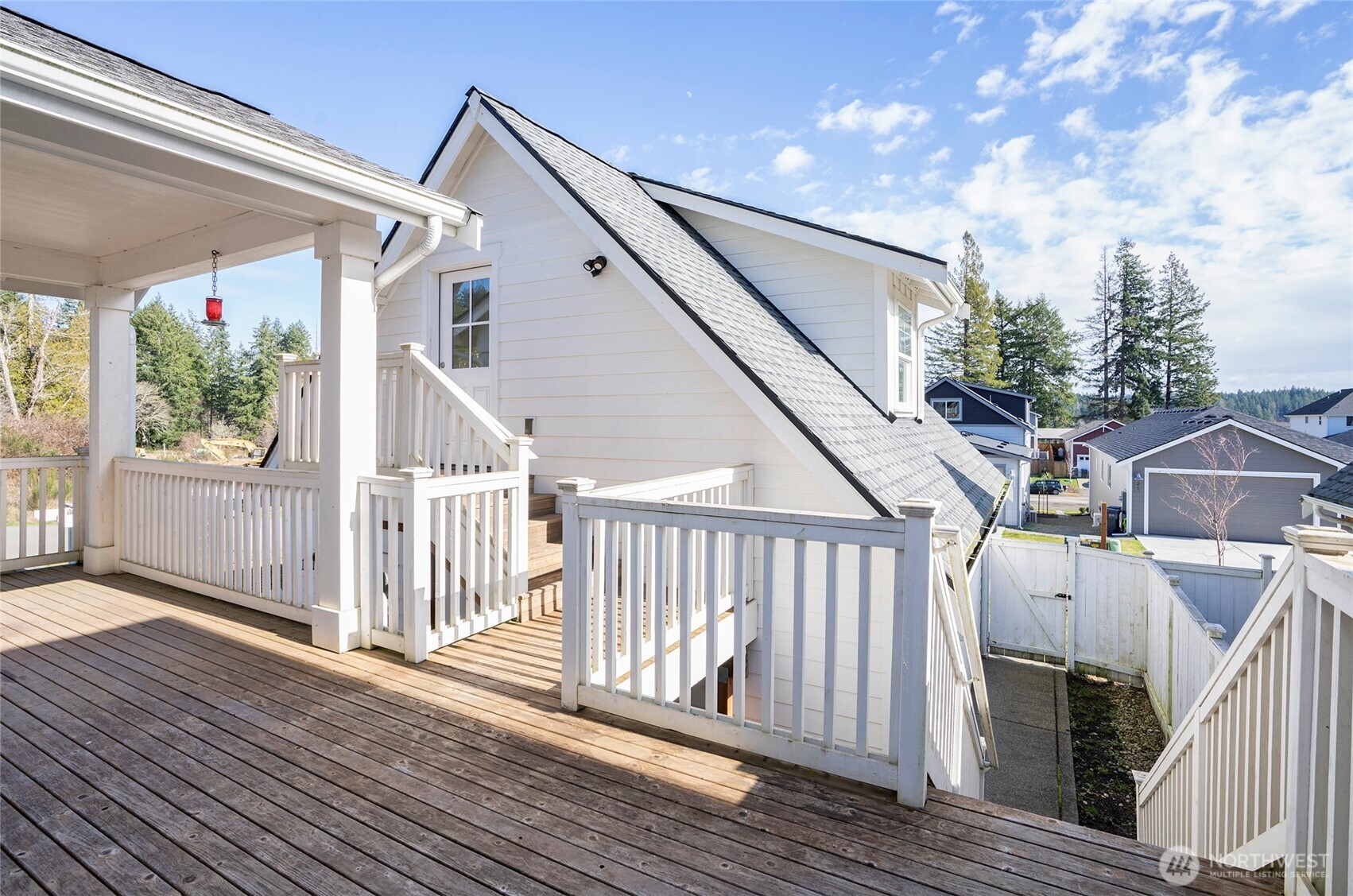 10 East Compass Lane Allyn, WA 98524 - Photo 27 of 35 a view of a house with wooden deck stairs and furniture