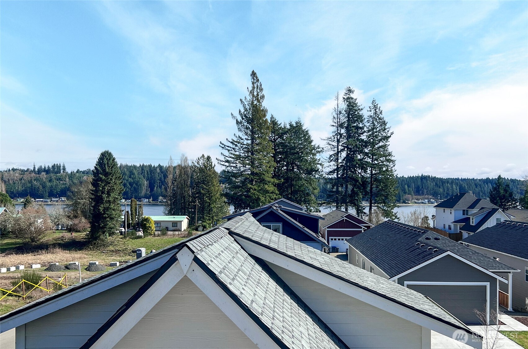 10 East Compass Lane Allyn, WA 98524 - Photo 30 of 35 a roof deck with table and chairs and wooden floor